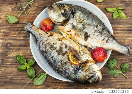 Yummy baked dorado fish on rustic wooden table. 132531886