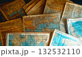 Vintage travel background with old map, passport, mobile phone, and travel books flat lay 132532110