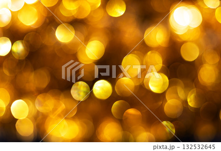 Golden bokeh background with soft glowing circles of light creating festive and luxurious atmosphere. Ideal for holiday designs, party invitations, luxury-themed visuals, celebration, elegance, warmth 132532645
