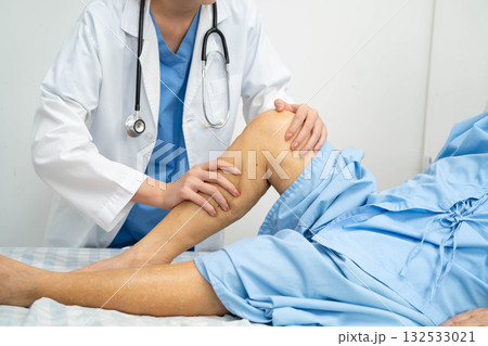 Doctor checking Asian elderly woman patient with scar knee replacement surgery in hospital. Doctor checking Asian elderly woman patient with scar knee replacement surgery in hospital. 132533021