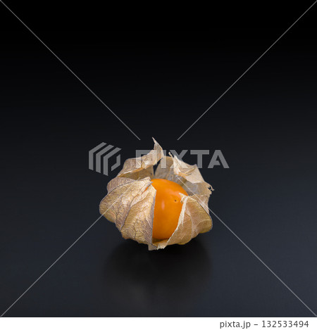 Goldenberry, groundcherry, or poha, front view and close-up, on a black glass plate. Ripe, fresh Physalis peruviana, also called cape gooseberry, a bright orange fruit, with papery lampion-like husk. Goldenberry, groundcherry, or poha, front view and close-up, on a black glass plate. Ripe, fresh Physalis peruviana, also called cape gooseberry, a bright orange fruit, with papery lampion-like husk. 132533494