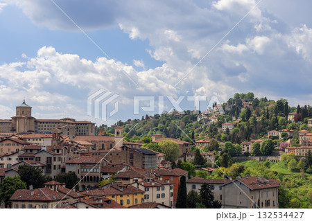 Bergamo upper town panorama showing domed seminary, San Vigilio hill and castle ruins above villas Bergamo upper town panorama showing domed seminary, San Vigilio hill and castle ruins above villas 132534427