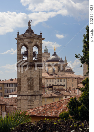 Vertical composition of Bergamo skyline showing cathedral bells, domes, spires and rooftops 132534428