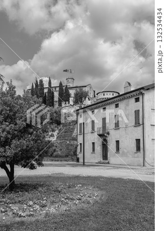 Brescia Castle in black and white showing Mirabella Tower rising above park under clouds 132534434