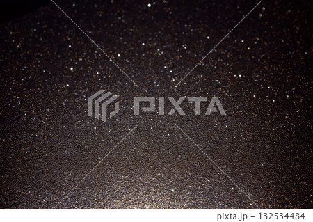 Dark glitter texture illuminated from below with surface detail and rare subtle sparkles 132534484