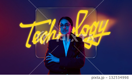 Bold poster. Confident businesswoman standing with neon technology sign on gradient background Bold poster. Confident businesswoman standing with neon technology sign on gradient background 132534998