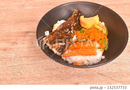 grilled saba fish or mackerel topping crab stick and shrimp egg couple sweet egg on japanese rice in bowl 132537733