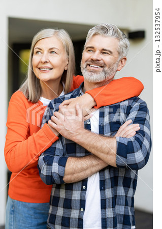 Senior man and woman together near their house looking happy and contented 132537954