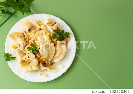 Warm comforting plate of traditional dumplings with fried onions Warm comforting plate of traditional dumplings with fried onions 132538365