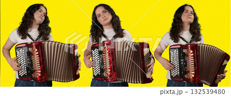 Young woman with a button accordion. Adult woman plays the button accordion Young woman with a button accordion. Adult woman plays the button accordion 132539480