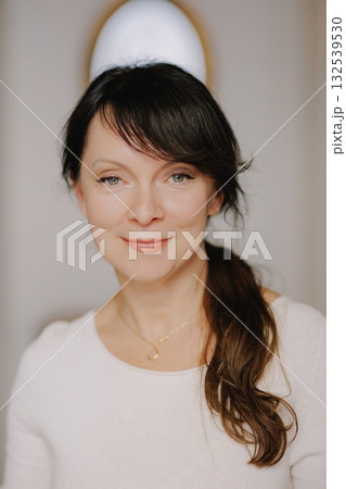 Mature woman smiling confidently, looking at camera Mature woman smiling confidently, looking at camera 132539530