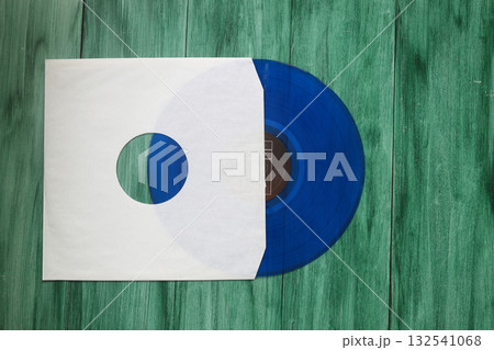 Aged White paper cover and vinyl LP record isolated on rusty background 132541068