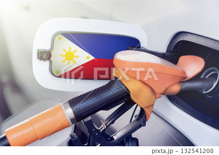 flag Philippines on the lid of the gas tank of a car at a gas station in close-up. High or low prices for gasoline and diesel fuel at Philippine gas stations. fuel shortage for cars in the Philippines flag Philippines on the lid of the gas tank of a car at a gas station in close-up. High or low prices for gasoline and diesel fuel at Philippine gas stations. fuel shortage for cars in the Philippines 132541208