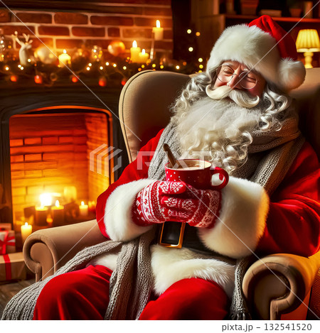 Fanta sitting in armchair by fireplace with cup of tea in hands, Christmas setting 132541520