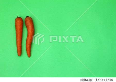 Fresh carrots isolated on green background. Close up of Carrots. 132541730