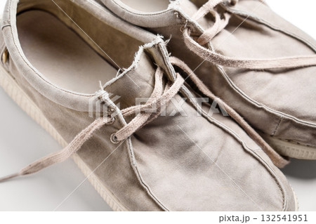 Old fabric shoes with laces. Worn casual aged footwear  132541951
