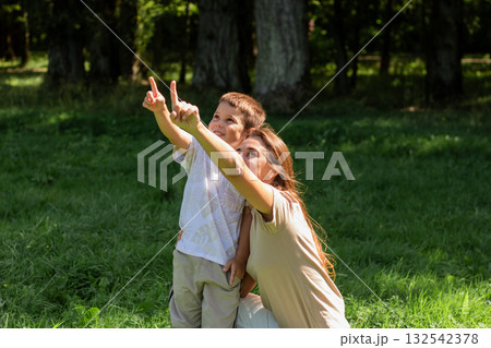 Serene moment of connection as mother and son watching nature. Peaceful scene evokes calmness, mindfulness, and simple pleasures of family life. 132542378