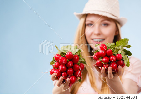 Happy woman giving radish 132544331