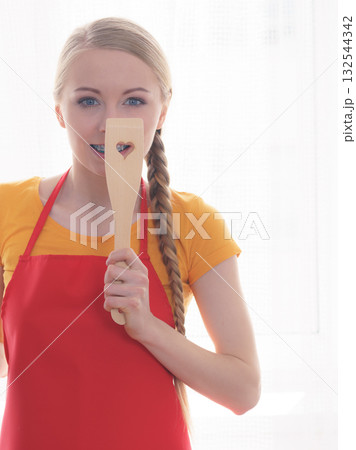 Woman holding cooking pan and spatula 132544342