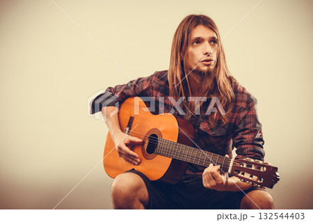 Sitting man playing guitar. Sitting man playing guitar. 132544403