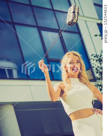 Cheerful fashionable woman in city 132544613