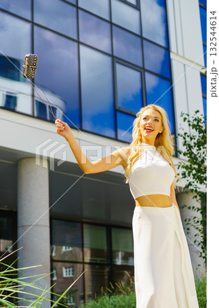 Cheerful fashionable woman in city 132544614