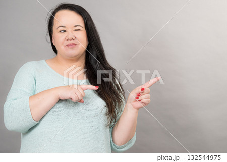 Woman pointing at copy space Woman pointing at copy space 132544975