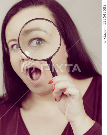 Adult woman with magnifying glss 132545085