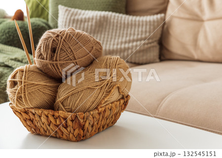 Basket with Yarn Balls on White Table in Cozy Living Room Basket with Yarn Balls on White Table in Cozy Living Room 132545151