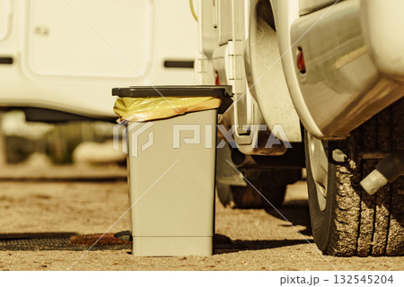 Trash can in front of caravan 132545204