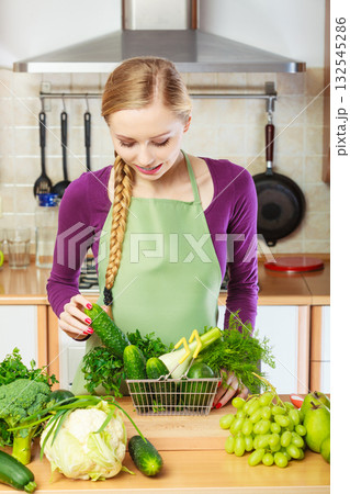 Woman having vegetables in shopping basket Woman having vegetables in shopping basket 132545286