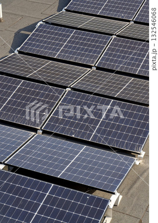 Solar panels on roof of apartment building, renewable green sustainable energy concept, water cooling, aerial view Solar panels on roof of apartment building, renewable green sustainable energy concept, water cooling, aerial view 132546068