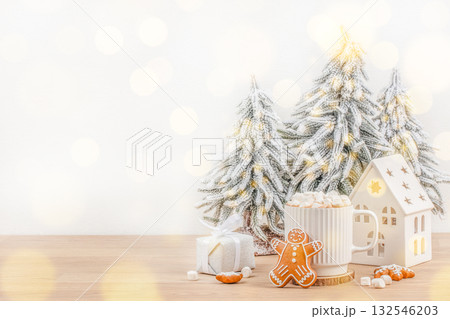 Cozy Christmas concept with red mug of hot chocolate, marshmallows, and gingerbread cookies symbolizing warmth, comfort, and festive holiday spirit Cozy Christmas concept with red mug of hot chocolate, marshmallows, and gingerbread cookies symbolizing warmth, comfort, and festive holiday spirit 132546203