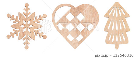Collection of wooden Christmas decorations including snowflake, heart, and tree shapes isolated on white background 132546310