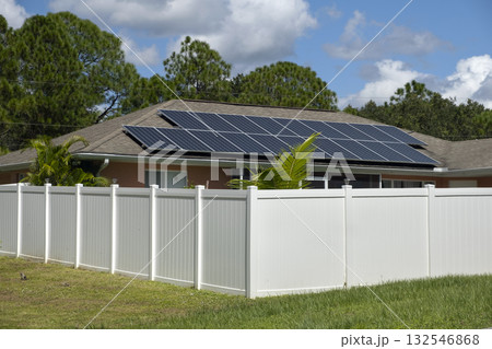 White vinyl fence surrounding private property grounds for backyard protection and privacy in southern Florida 132546868