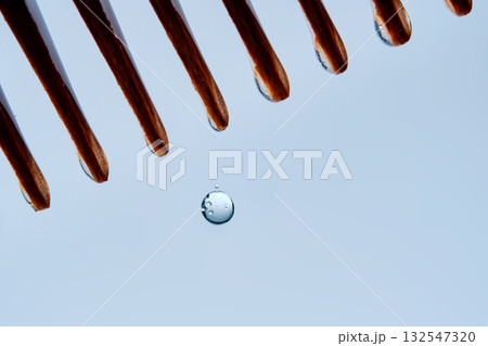 A comb with hair serum. The photo shows the texture of the cosmetic product. A comb with hair serum. The photo shows the texture of the cosmetic product. 132547320