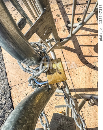 Metal Chain and Padlock on Barrier under Sunlight Metal Chain and Padlock on Barrier under Sunlight 132547358