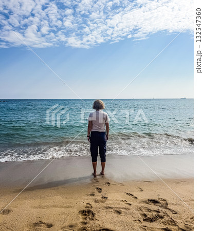 Woman Standing on Beach Looking at the Sea 132547360
