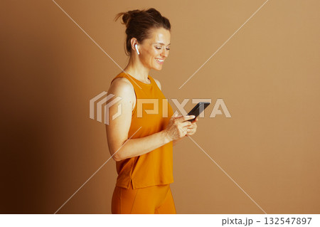 Active Woman Engaged with Smartphone in Profile 132547897