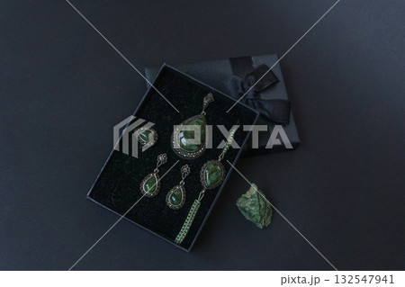 Silver jewelry set with peridot in a luxury gift box with raw stone and copy space Silver jewelry set with peridot in a luxury gift box with raw stone and copy space 132547941