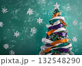An illustration of a christmas tree decorated with purple, white,orange ribbons. 132548290