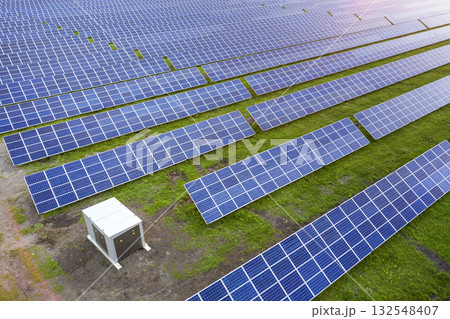 Surface of solar photo voltaic panels system producing renewable clean energy on green grass background. Surface of solar photo voltaic panels system producing renewable clean energy on green grass background. 132548407