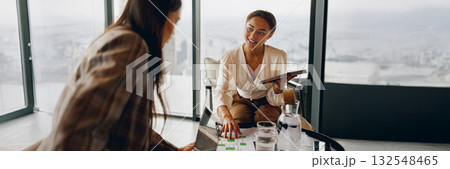 A Collaborative Business Meeting Taking Place in a Modern Office Space Environment 132548465