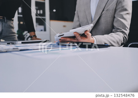 Accounting company provide finance and taxation planning for profitable cash flow, Auditor and accountant team working in office, analyze financial data and accounting record with calculator.Insight Accounting company provide finance and taxation planning for profitable cash flow, Auditor and accountant team working in office, analyze financial data and accounting record with calculator.Insight 132548476