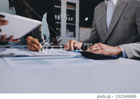 Accounting company provide finance and taxation planning for profitable cash flow, Auditor and accountant team working in office, analyze financial data and accounting record with calculator.Insight Accounting company provide finance and taxation planning for profitable cash flow, Auditor and accountant team working in office, analyze financial data and accounting record with calculator.Insight 132548480