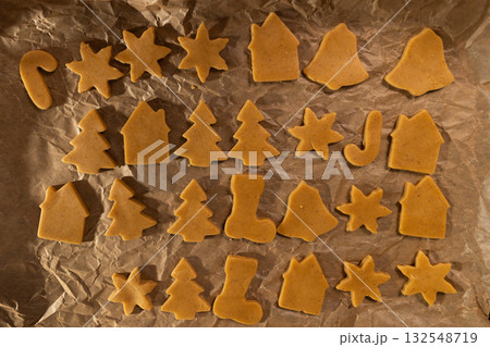 Raw Gingerbread Dough Cutouts Ready for Baking on Parchment Raw Gingerbread Dough Cutouts Ready for Baking on Parchment 132548719