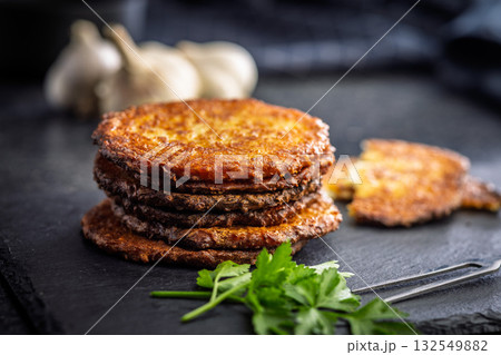 Fried potato pancake on black table. 132549882