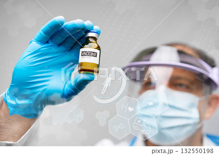 Scientist examines a vaccine vial in a lab during a clinical research session Scientist examines a vaccine vial in a lab during a clinical research session 132550198