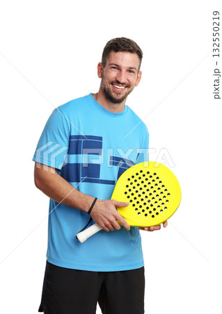 Smiling man holds bright yellow paddle for racket sport indoors Smiling man holds bright yellow paddle for racket sport indoors 132550219