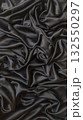Elegant black silk fabric with luxurious folds and flowing drapes texture background Elegant black silk fabric with luxurious folds and flowing drapes texture background 132550297